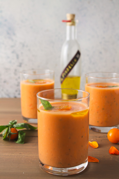 Three glasses of corn tomato gazpacho with lime olive oil