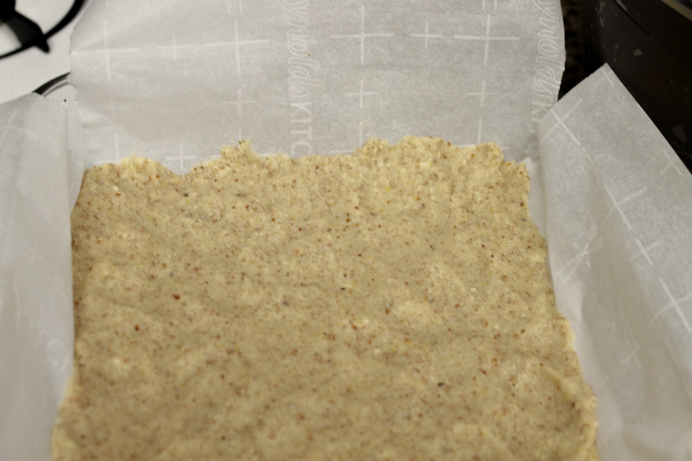Almond and corn flour base pressed into pan.