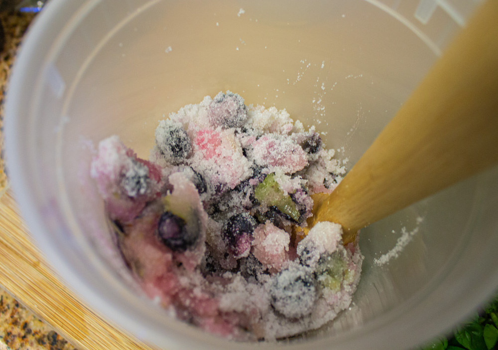 Muddling blueberries into sugar