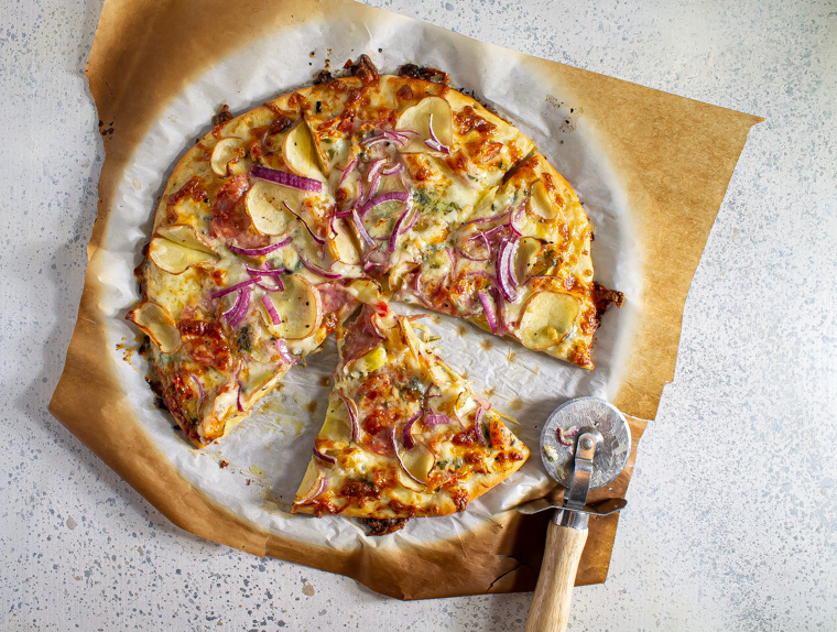 Pizza with red onion, potato, salami, and blue cheese