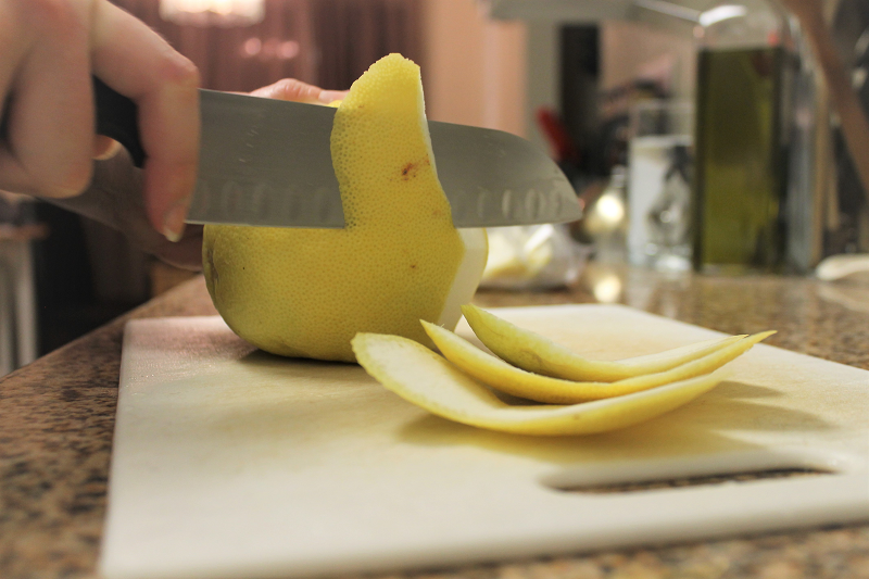 Removing the rind on a pomelo.