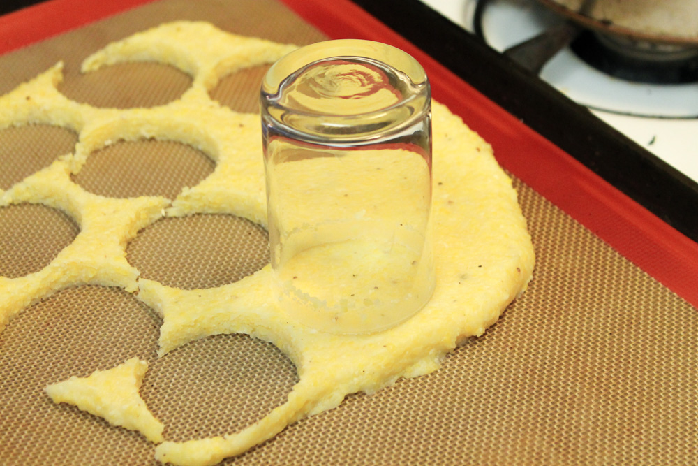 Polenta being cut into discs