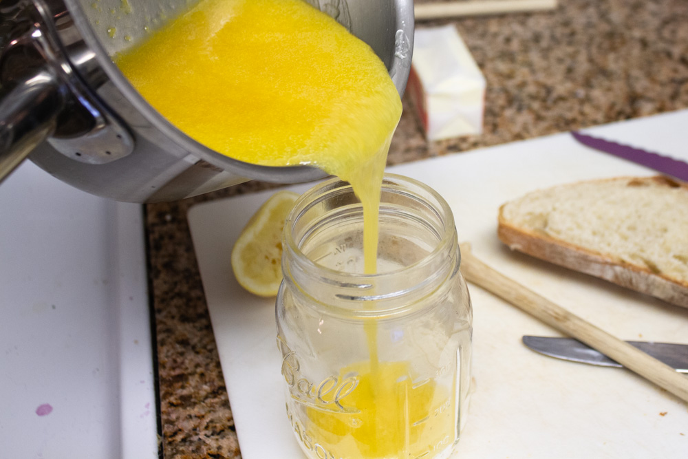 Pouring lemon curd into glass jar