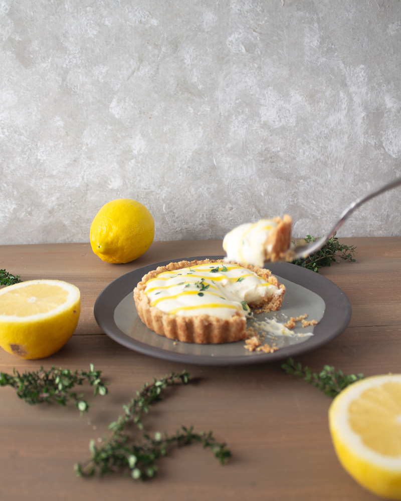 Lemon thyme tart on plate with fork and bite