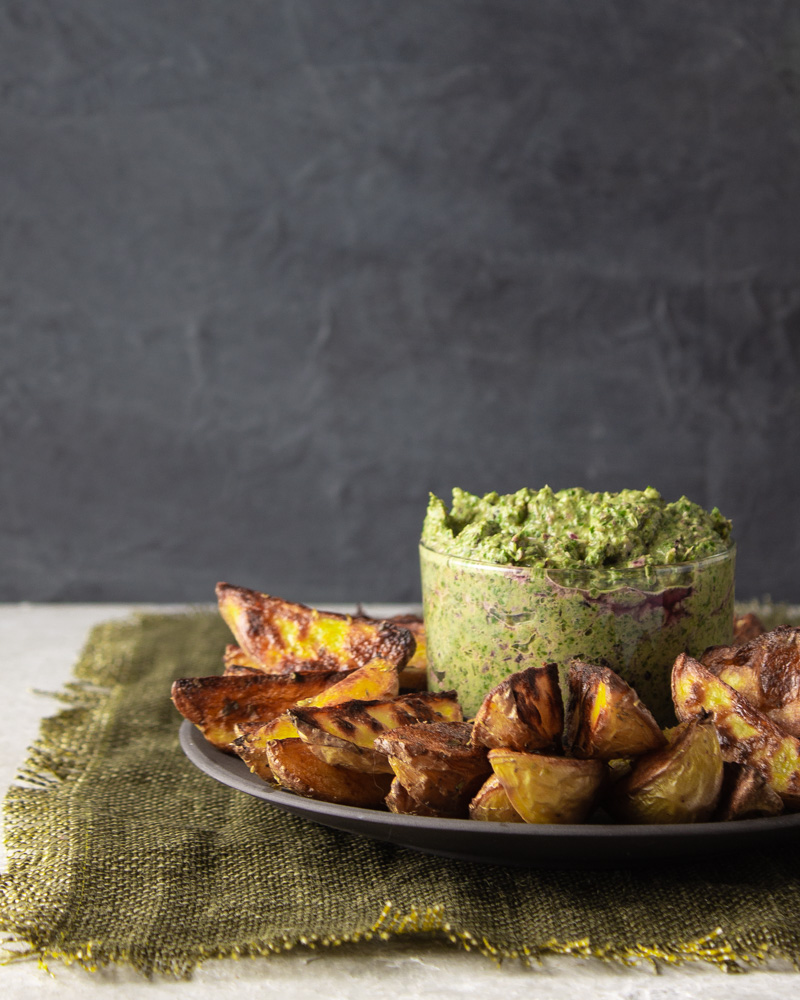 Side view of greens spread with potato wedges