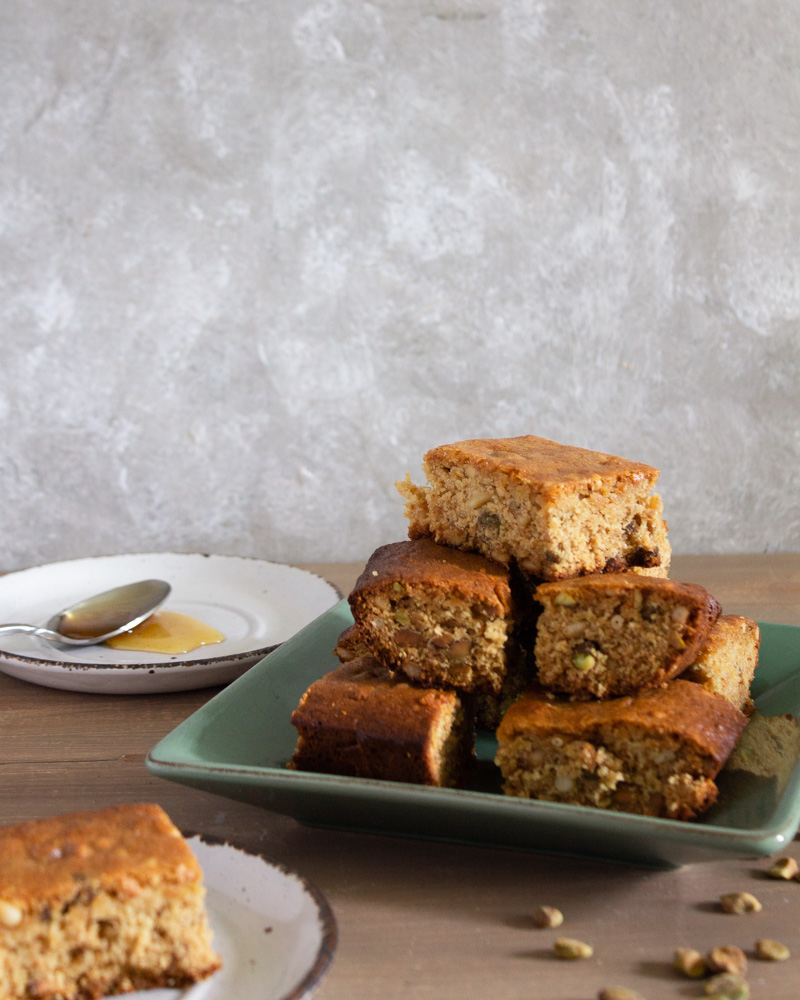 Baklava blondies with honey on plate and piece in front