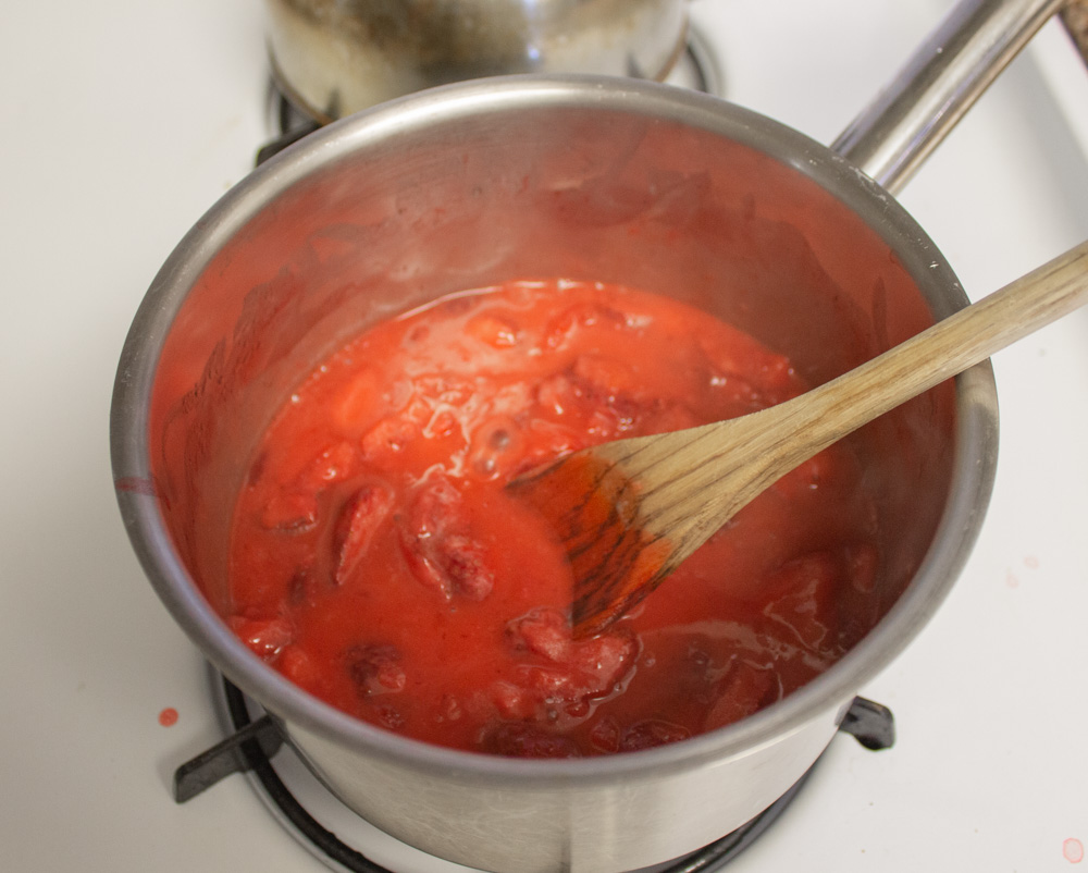 Strawberry jam in pot on stove