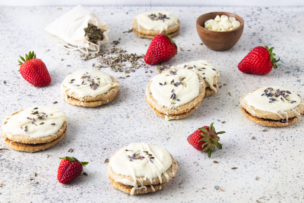 45 degree angle shot of strawberry lavender cookies with all white background