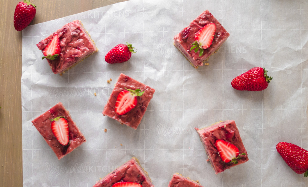 Overhead shot of strawberry bars on parchment