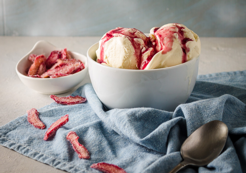 Blue napkin, rhubarb wine syrup on ice cream, candied rhubarb