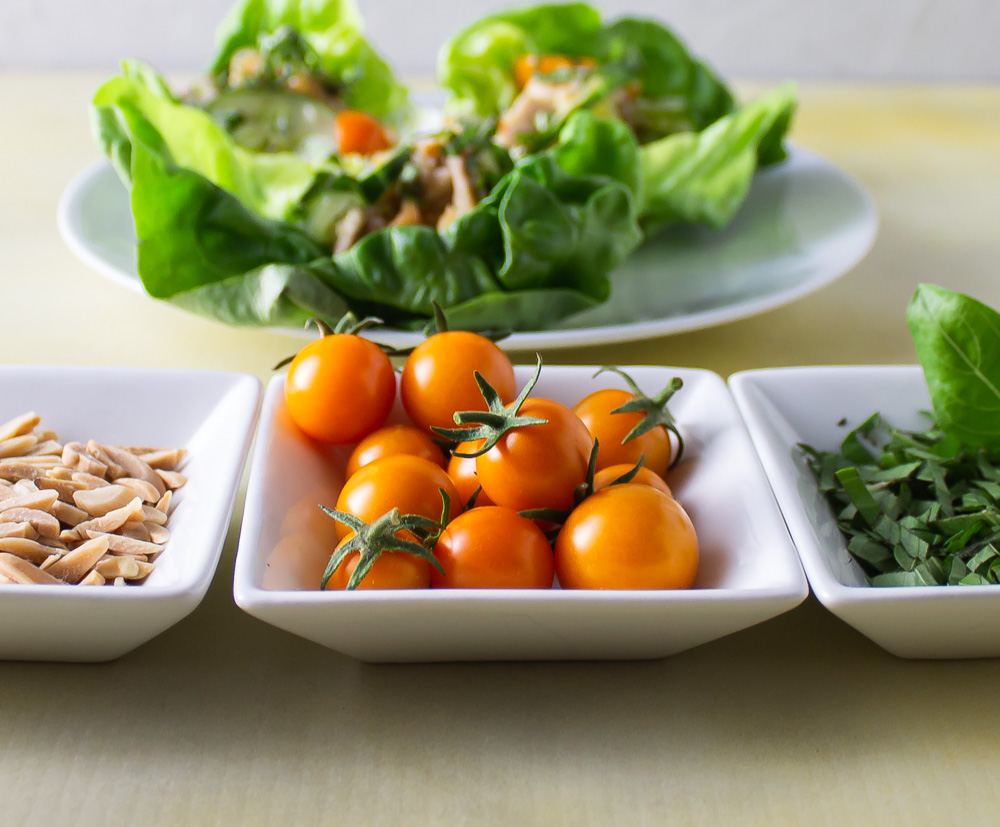 Close up of sun gold tomatoes with lettuce wraps in background