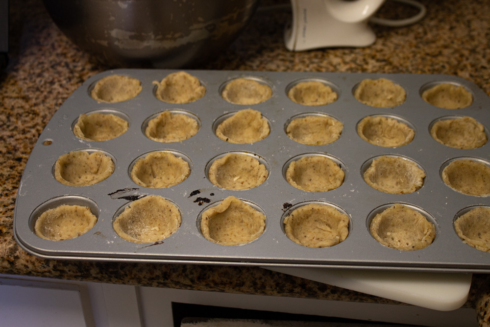 Pastry cases in the pan ready to be baked