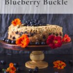 Blueberry buckle on cake stand with flowers