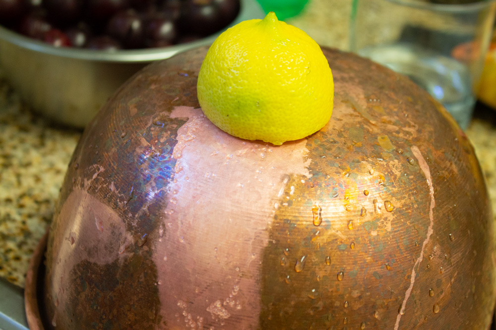 CLeaning a copper bowl with lemon