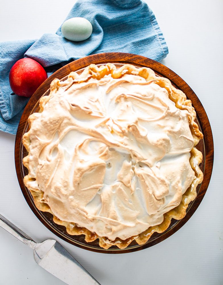 Overhead shot of whole stone fruit meringue pie