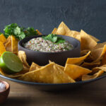 Side view salsa in a grey bowl with tortilla chips
