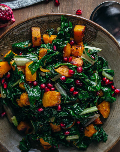 Overhead shot of swiss chard and buttern nut squash with pomegranates