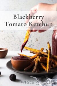 sweet potato fry dipping in blackberry ketchup