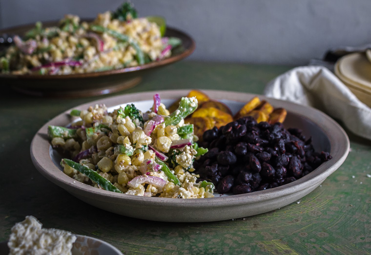 Plate with corn salad, black beans, and plantain