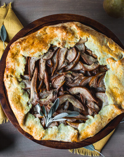 Overhead shot of olive oil pear galette on stand