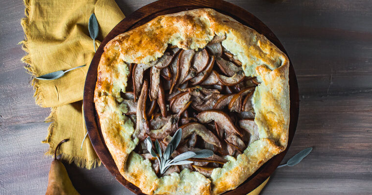 Overhead shot of olive oil pear galette on stand