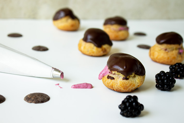 blackberry cream puffs with piping bag