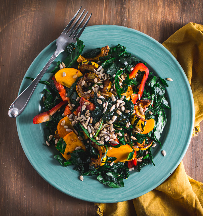 Delicata and persimmon salad on gree plate