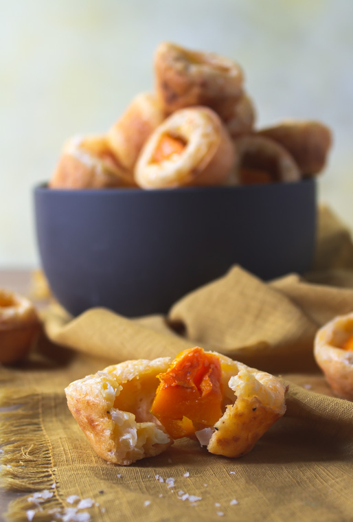 Ripped open tapioca cheese bread with butternut in front of bowl