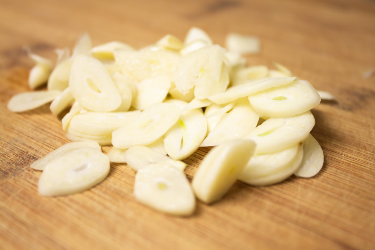 Sliced garlic on a cutting board
